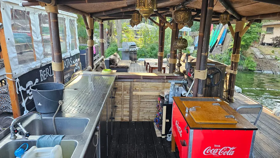 Outdoor bar on boat with Coca-Cola cooler.