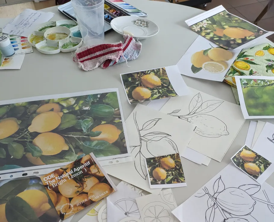 Art materials for lemon painting on table.