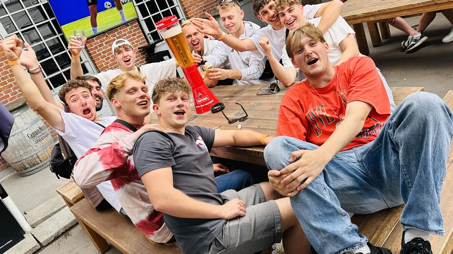 Group celebrating at outdoor table with drink tower.