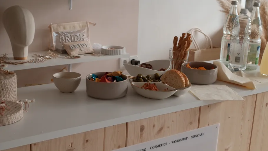 Table with snacks, drinks, and decor in room.