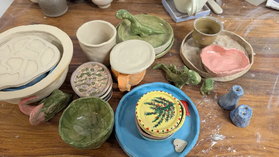 Various ceramic items displayed on wooden table.