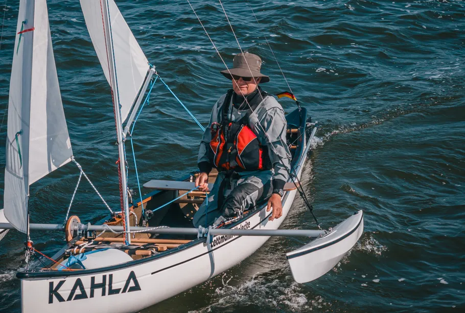 Man sailing small boat on the sea.