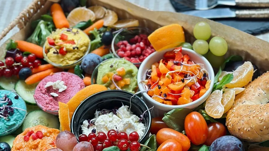 Colorful dips and fruits on a platter.