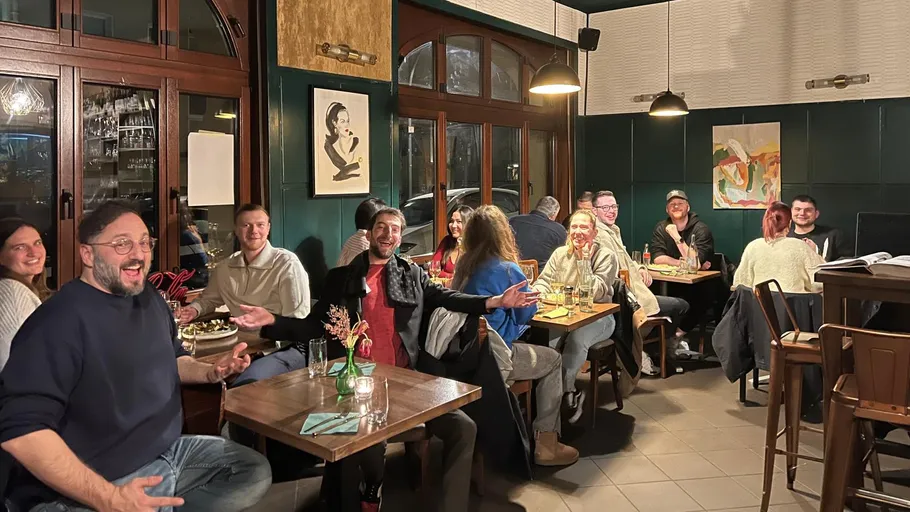 Group of people socializing in a restaurant.