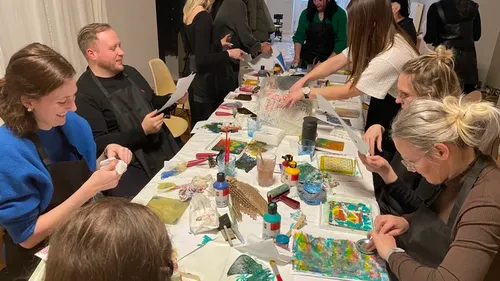 People crafting together at a long table.