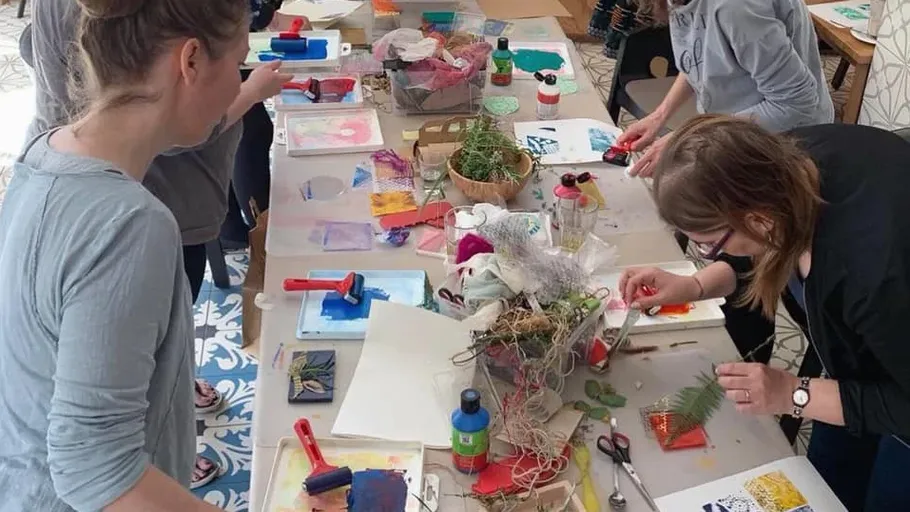People crafting with various art supplies indoors.