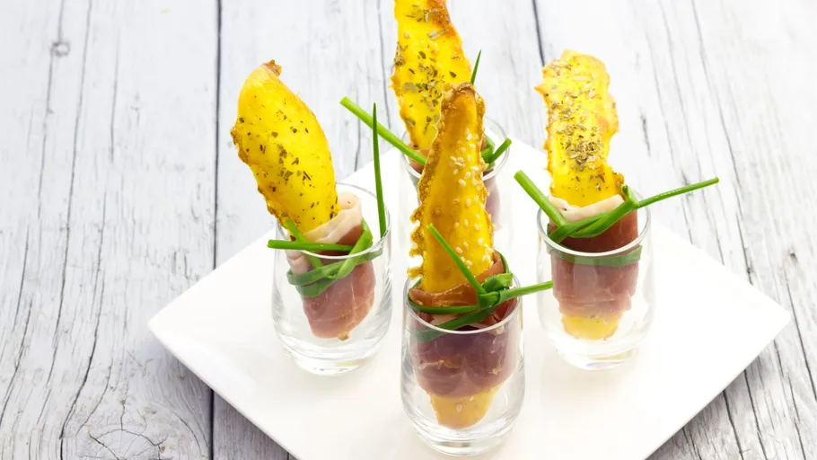 Stuffed pears in glasses on wooden table.
