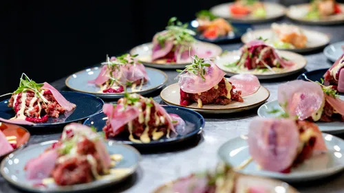 Gourmet dishes with beet, sauce, and greens.