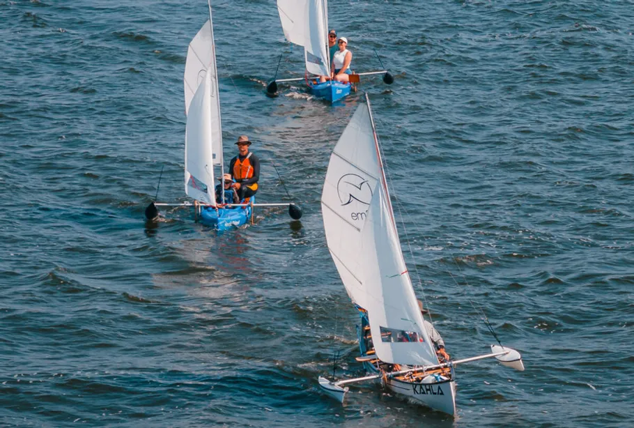 Sailboats racing in open water.