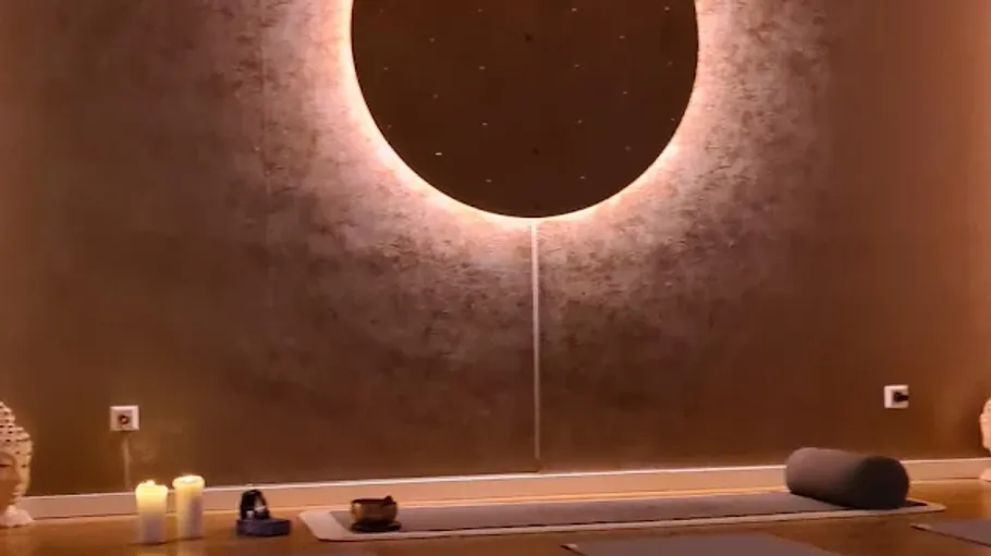 Yoga mat and candles in a tranquil room.