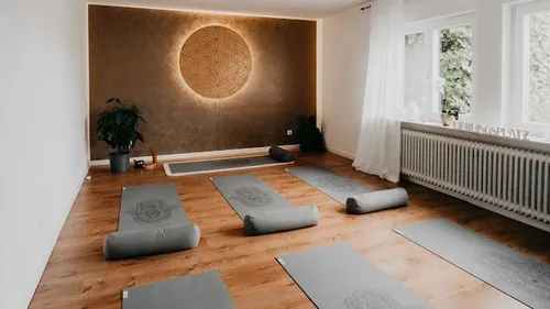 Yoga mats on floor, serene studio setting.