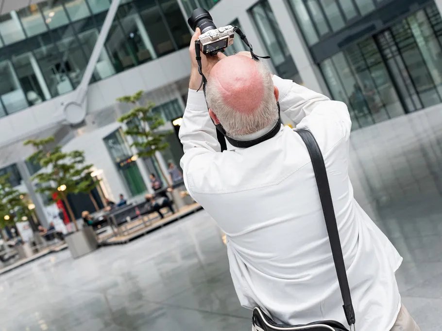 A photographer takes pictures on a modern surface.