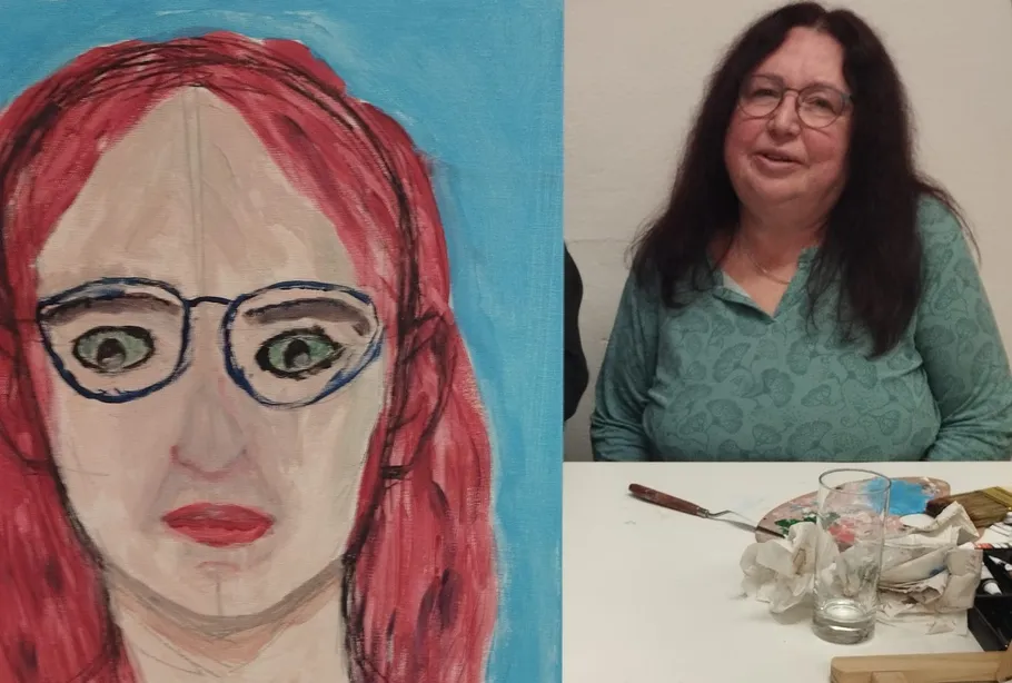 Woman sitting beside her painted portrait.