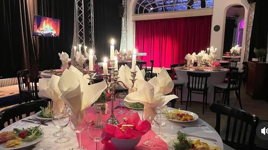 Elegant dinner setup with candlelit tables.