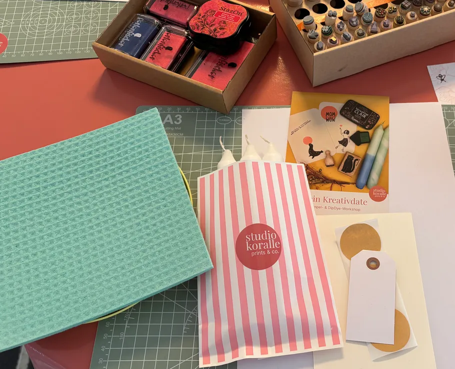 Craft supplies on a red table.