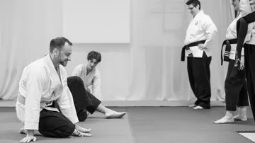 People practicing martial arts in a dojo.
