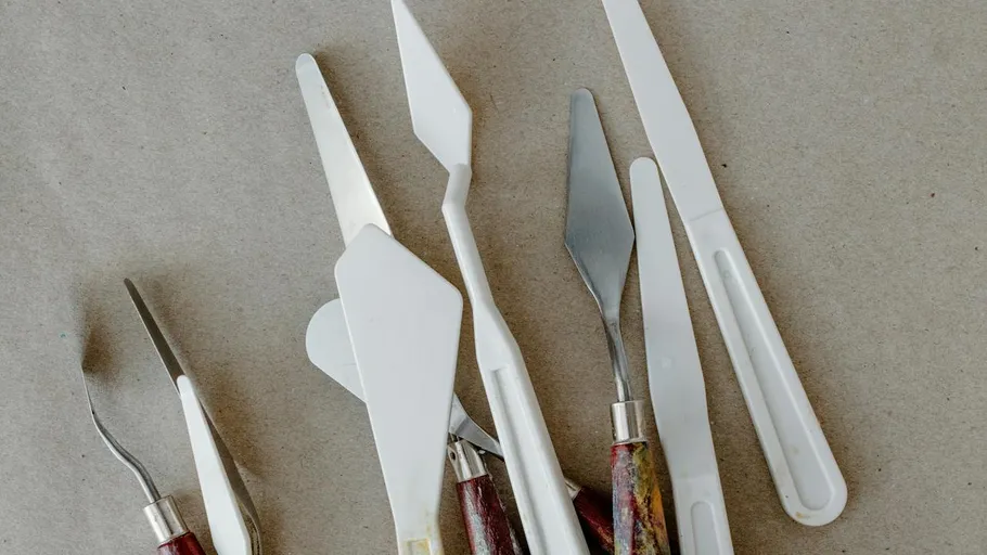 Palette knives on a textured surface.