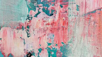 Abstract paint strokes in pink and teal.