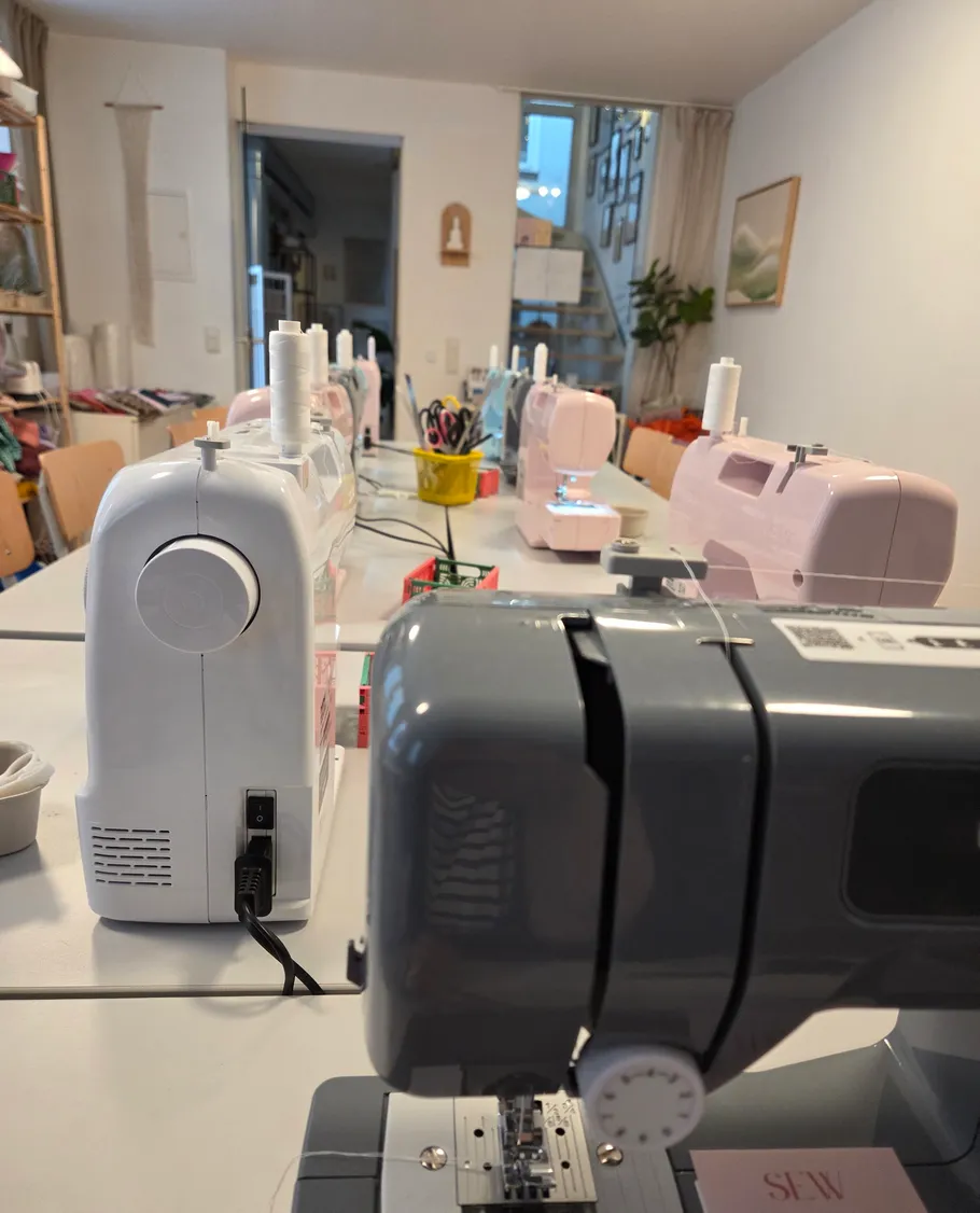 Nähmaschinen in einem Workshop aufgestellt.