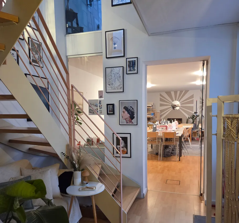 Staircase with art leading to dining room.