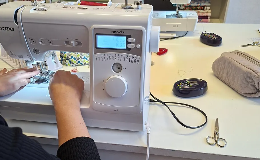 Person sewing with a Brother machine.
