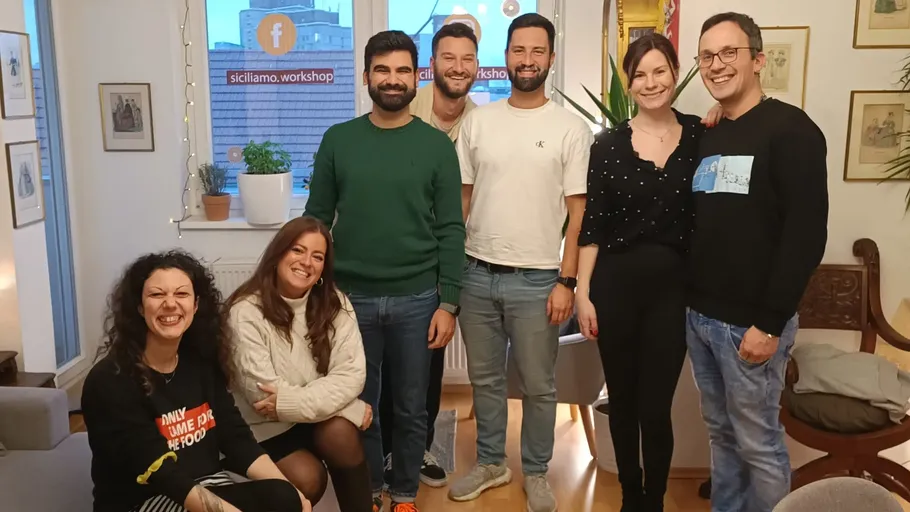 Group of seven people in a living room.