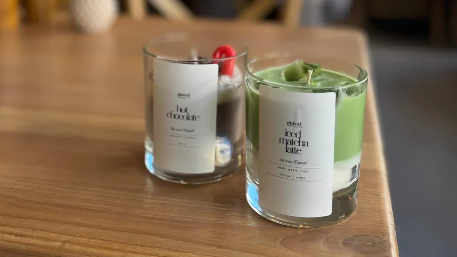 Two candles on a wooden table.