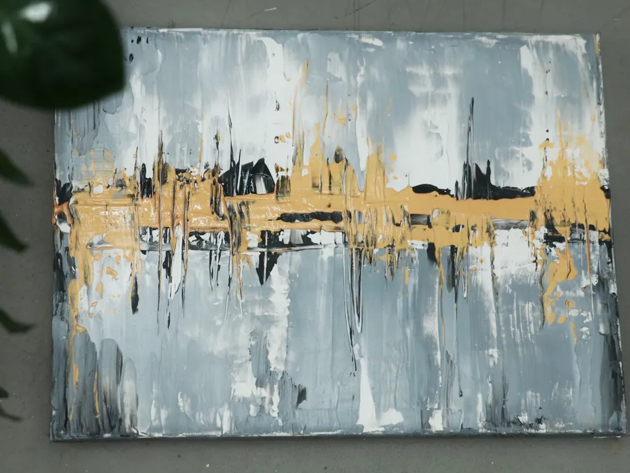 Abstract painting shows layers of yellow, grey and black paint.