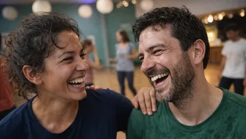 Two people laughing together in a studio.
