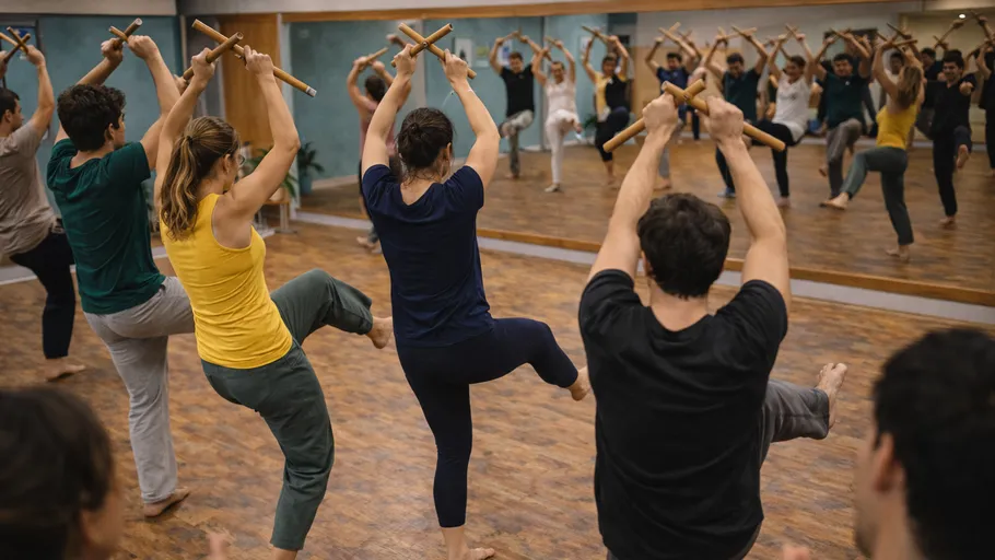 People dancing with sticks in studio.