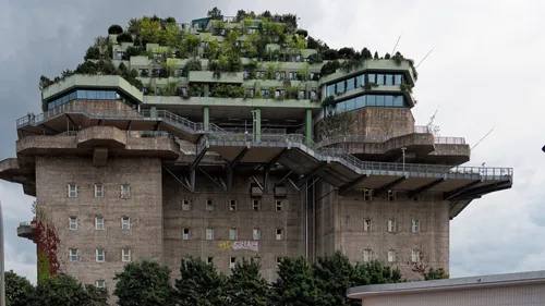 Building with rooftop garden and cloudy sky.