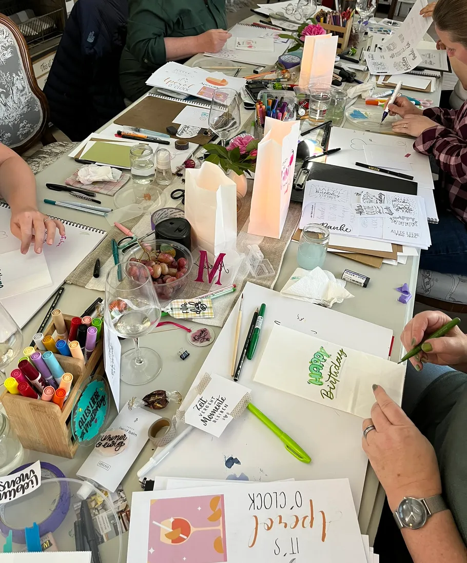 People creating crafts at a table.