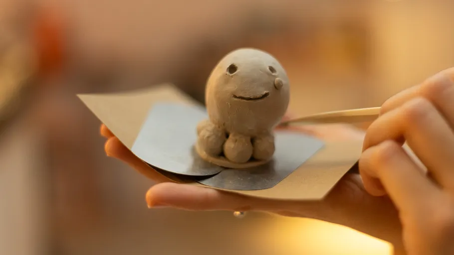 Clay figure smiled, crafted by hand.