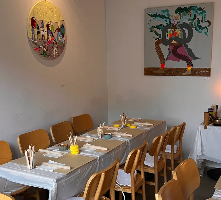 Restaurant interior with artwork and set tables.