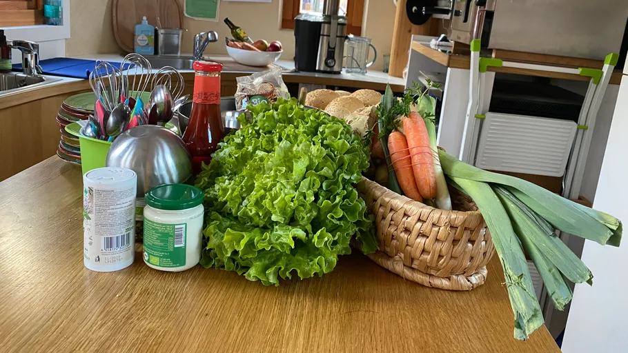 Vegetables and utensils on a kitchen countertop.