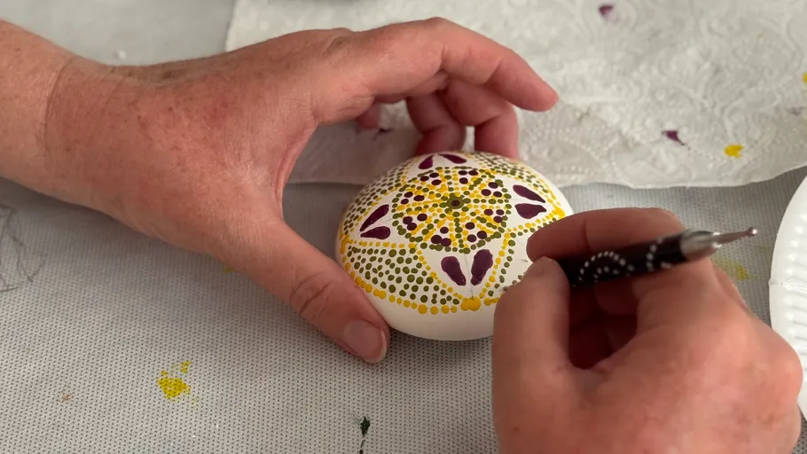 Hand painting decorative pattern on white egg.