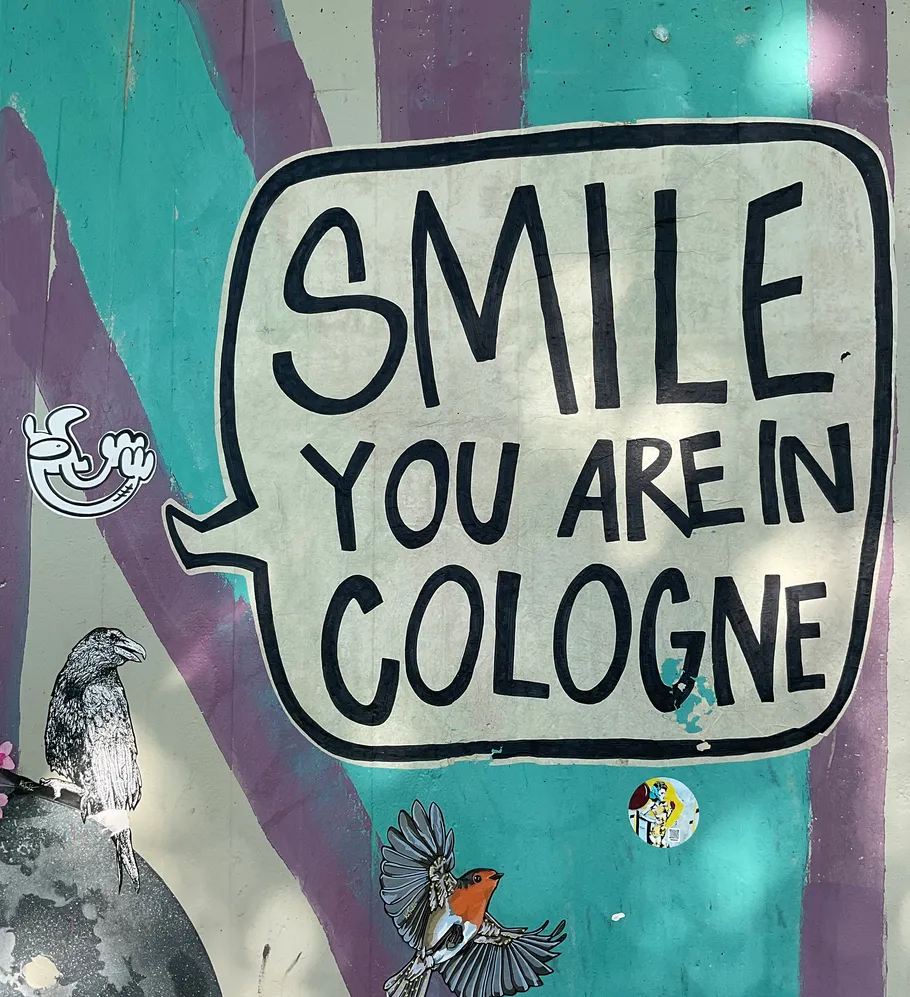 Mural with text and birds on wall.