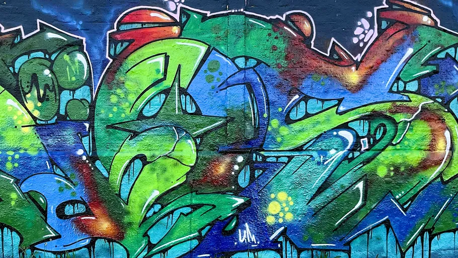 Colorful graffiti mural on a brick wall.