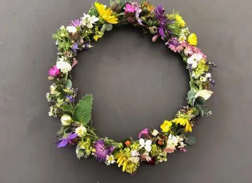 Colorful floral wreath on a gray background.