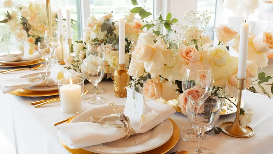 Elegant table setting with roses and candles.