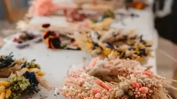 Colorful dried flower wreaths on a table.