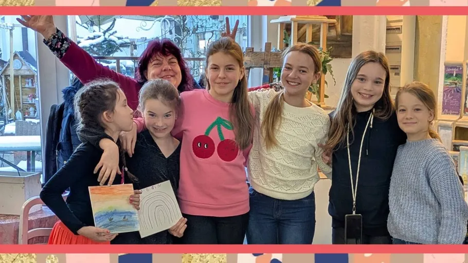 Group of smiling people inside room.