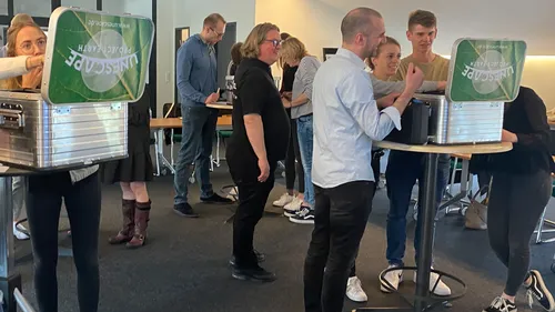 People engaging with escape room tasks in room.