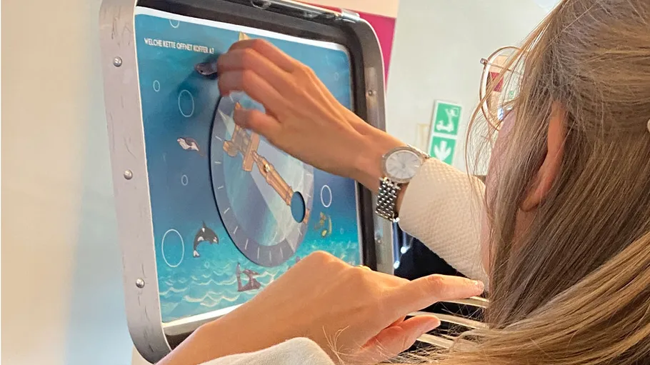 Person using interactive screen on airplane.