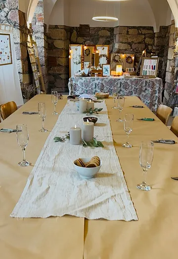 Decorated table with candles and snacks indoors.