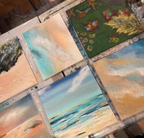 Abstract paintings displayed on a table.