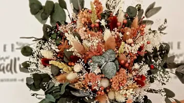 Colorful flower bouquet with green leaves.