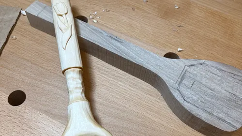 Carved wooden spoon with tulip design.