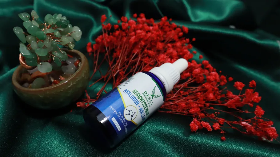 Serum bottle displayed against red and green decor.