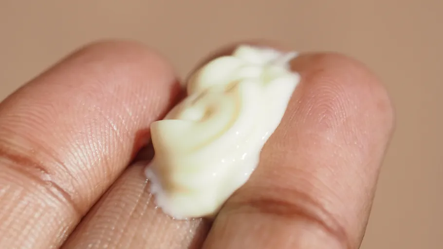 Cream on fingers, close-up view.
